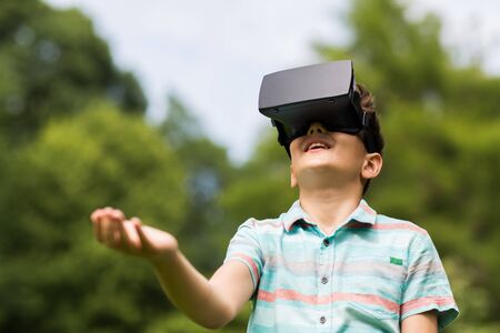 boy with virtual reality headset outdoors