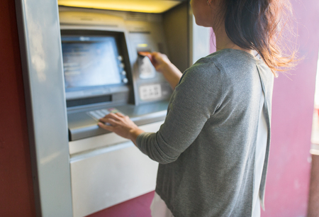 close up of woman inserting card to atm machineの写真素材