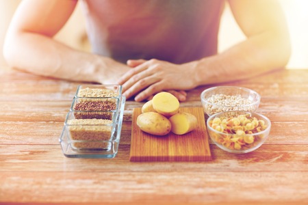 close up of male hands with carbohydrate foodの写真素材