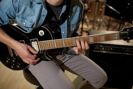 man playing guitar at studio rehearsal