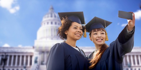 students or bachelors taking selfie by smartphoneの写真素材