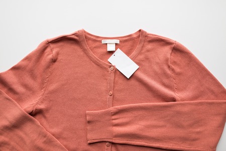 close up of cardigan with price tag
