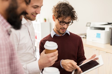 business team with tablet pc and coffee at office