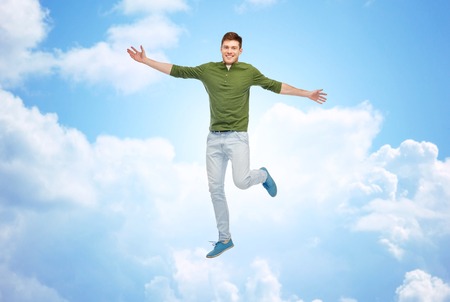 smiling young man jumping in air