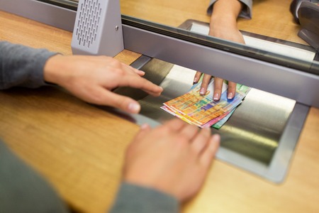 clerk giving cash money to customer at bank officeの写真素材
