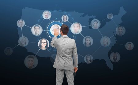 business, people, communication, cooperation and technology concept - businessman touching virtual screen with contacts icons and usa or america map over dark blue on backgroundの写真素材