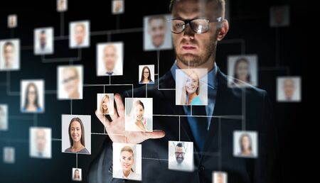 businessman touching screen with contact iconsの写真素材