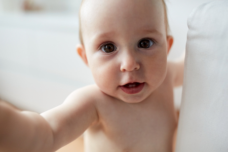close up of happy little baby boy or girl at homeの写真素材