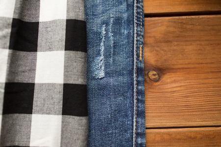 close up of checkered shirt and jeans on woodの写真素材