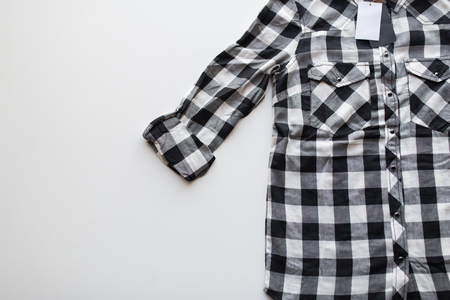 close up of checkered shirt on white background