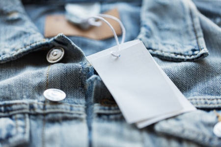 close up of denim jacket with white price tagの写真素材