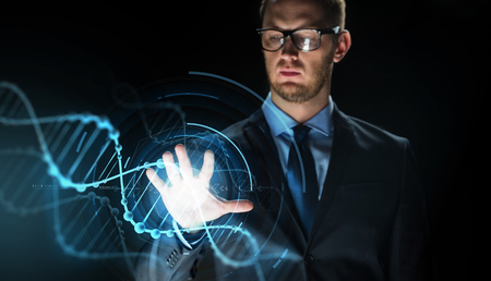 businessman with virtual dna molecule projectionの写真素材