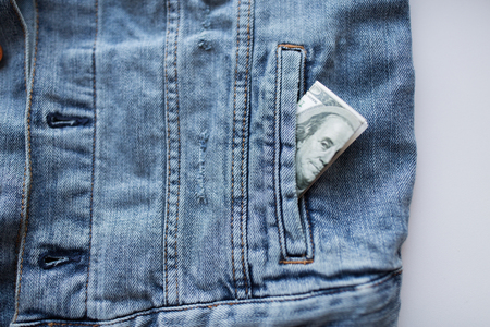 dollar money in pocket of denim jacket
