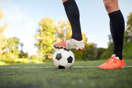 soccer player playing with ball on football field