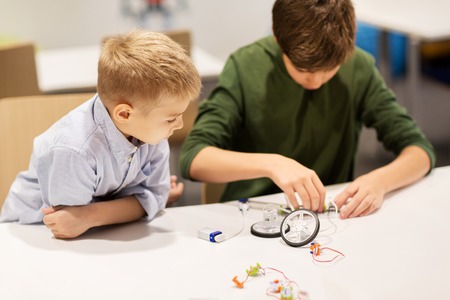 happy children building robots at robotics schoolの写真素材