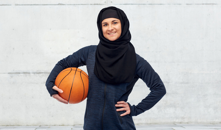 happy muslim woman in hijab with basketballの写真素材
