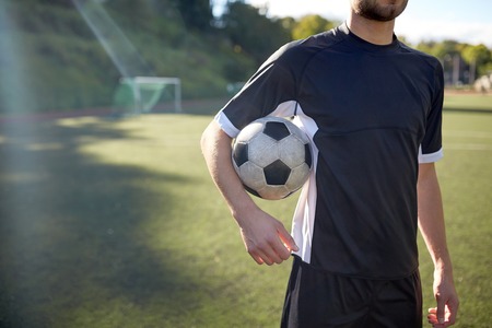 close up of soccer player with football on fieldの写真素材