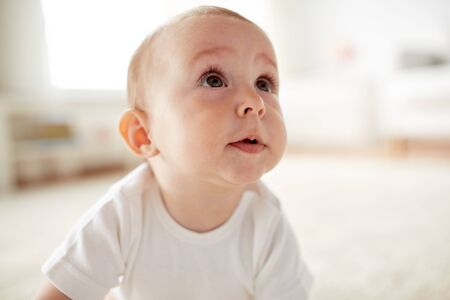 close up of happy little baby boy or girl at homeの写真素材
