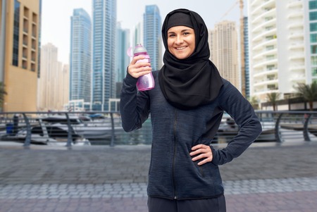 muslim woman with water bottle doing sportの写真素材