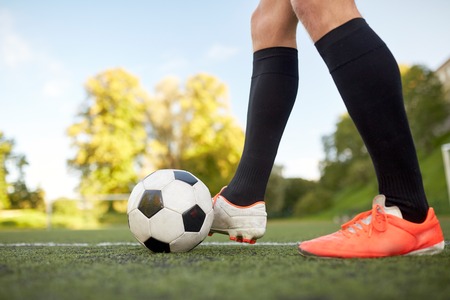 soccer player playing with ball on football fieldの写真素材