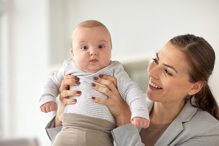 happy businesswoman with baby at office