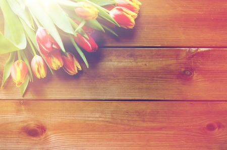 close up of tulip flowers on wooden tableの写真素材