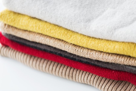 close up of stacked knitted clothes