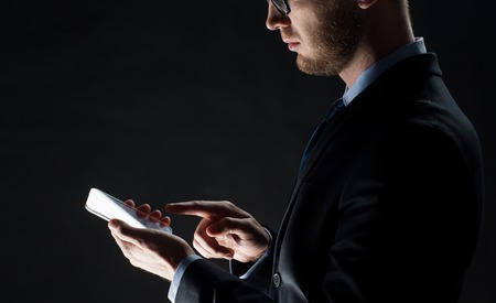 business, people and future technology concept - close up of businessman with transparent smartphone...