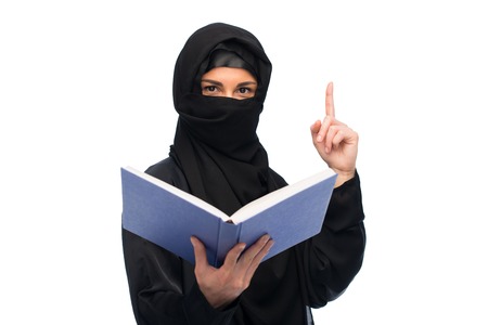 muslim woman in hijab with book over whiteの写真素材
