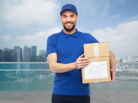 happy delivery man with boxes over singapore city