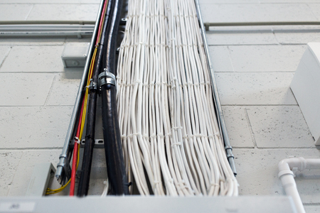 group of electricity cables at wall