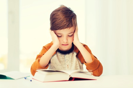 student boy reading book or textbook at homeの写真素材