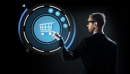 businessman pointing finger to shopping cartの写真素材