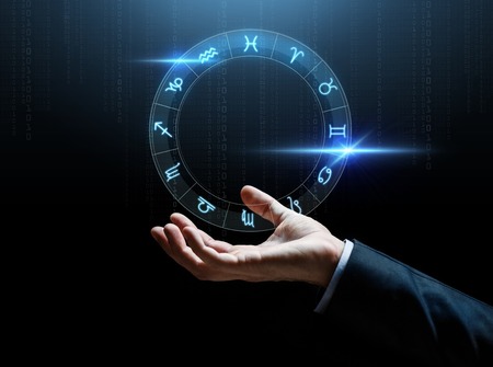 close up of businessman hand with signs of zodiacの写真素材