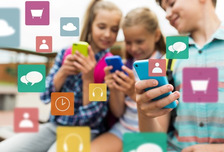 elementary school students with smartphonesの写真素材