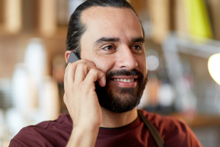 close up of man or waiter calling on smartphoneの写真素材