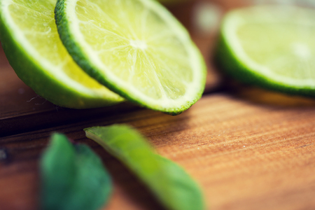 lime slices on wooden tableの写真素材