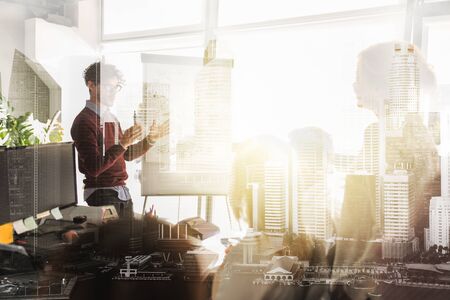 business, startup, presentation, strategy and people concept - man showing scheme on flipboard to creative team at office over urban double exposure effectの写真素材
