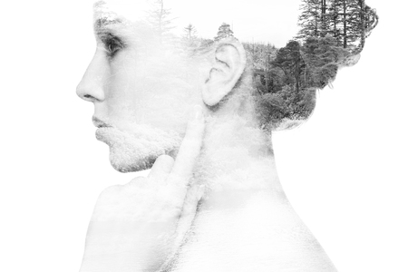 people, nature and beauty concept - beautiful young woman face with natural double exposure effect over white backgroundの写真素材