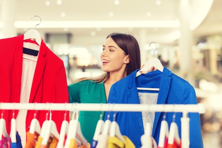 happy woman choosing clothes at home wardrobeの写真素材