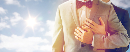 close up of male gay couple with wedding rings onの写真素材