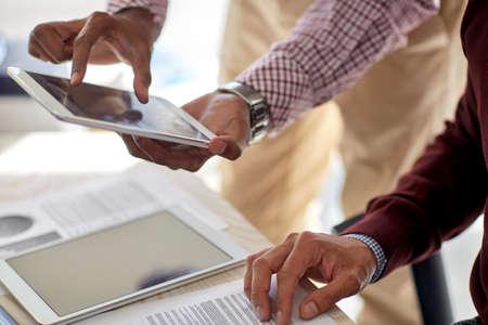 businessmen with tablet pc and papers at officeの写真素材