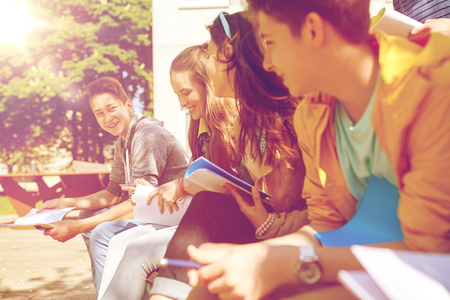 group of students with notebooks at school yardの写真素材