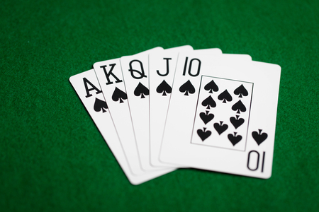 poker hand of playing cards on green casino cloth