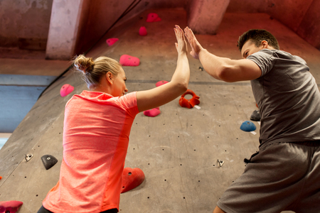 man and woman exercising at indoor climbing gymの写真素材