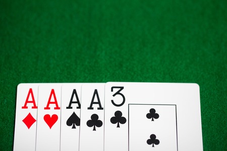 poker hand of playing cards on green casino cloth