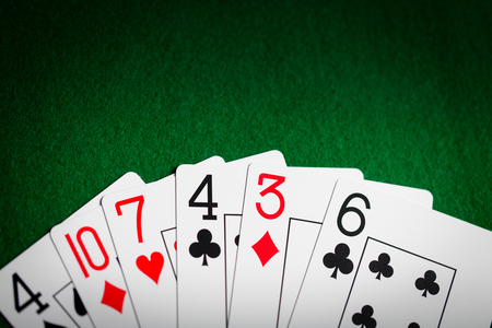 casino, gambling, games of chance, hazard and entertainment concept - poker hand of playing cards on...