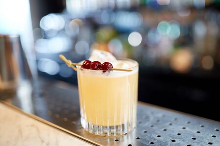 glass of cocktail with cherries at barの写真素材