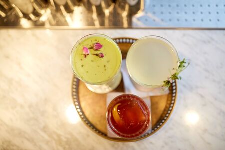 tray with glasses of cocktails at bar