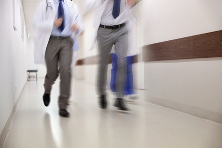 close up of medics or doctors running at hospitalの写真素材